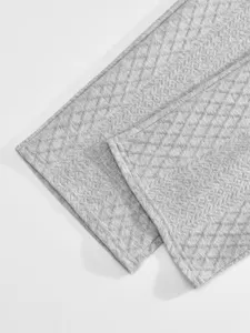 Grey jacquard fabric detail view showing texture and fine stitching for casual menswear.