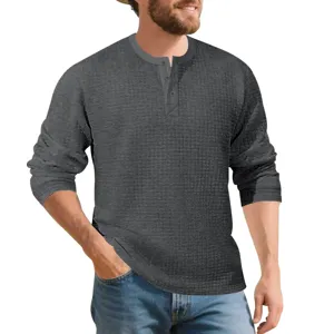 Detail view of men's dark grey waffle knit long sleeve Henley shirt with button placket.