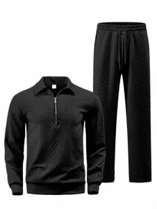 Detail view of the black jacquard polo sweatshirt and trousers set showing texture.