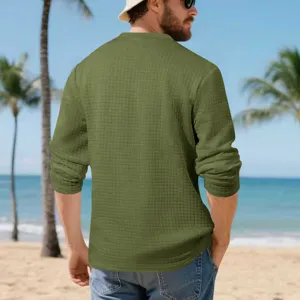 Green textured long sleeve shirt back view detail on beach, comfortable loose fit style.
