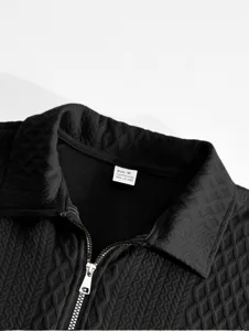 Close-up detail of mens black jacquard polo sweatshirt collar with zipper, premium texture.
