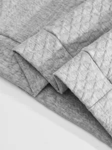 Grey men jacquard fabric detail view, fine quilted texture and neat stitching construction.