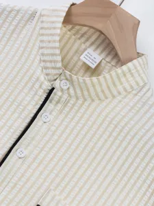 Close-up detail of mens striped mandarin collar short sleeve shirt fabric and buttons.