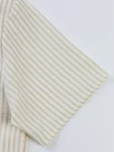 Close-up detail of mens striped seersucker short sleeve shirt fabric texture and neat stitching.
