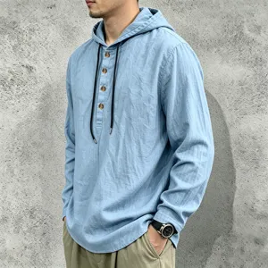 Detailed view of men's casual light blue long sleeve hooded linen shirt with wooden buttons.