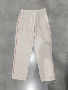 Men's casual loose straight leg sweatpants with drawstring waist and contrast red side stitching.