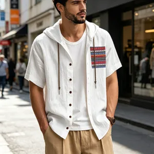 Detailed shot of men's summer linen hooded short-sleeve shirt with boho pocket in street scene.