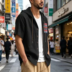 Detailed view of men's short sleeve hooded linen shirt with bohemian pocket on city street.