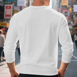 Detailed back view of mens solid white waffle knit long sleeve crewneck top in street.