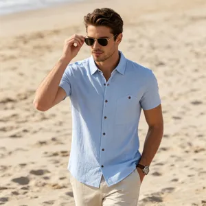 Outdoor beach scene detail of a stylish men's light blue short sleeve casual shirt.