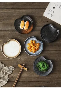 Top view of creative Japanese ceramic snack plates on rustic wooden table