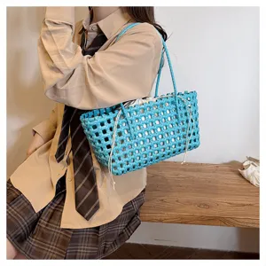 Stylish blue PVC woven tote bag for women, perfect for summer beach holidays and daily use.