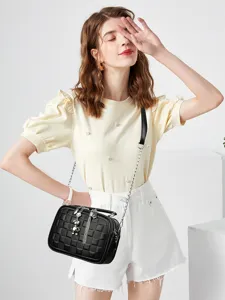 Fashion black quilted crossbody bag for women with chic chain strap and cute bear charm detail.