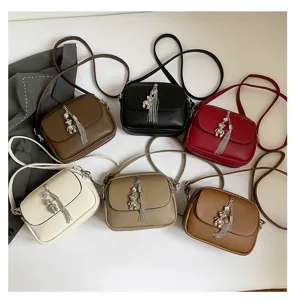 Women minimalist crossbody bag with cute metal bear pendant and tassel, stylish shoulder bag.