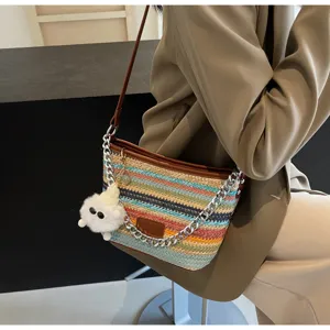 Stylish colorful woven straw bucket bag, casual summer crossbody bag with chain and plush charm.