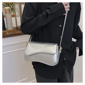 Stylish silver metallic asymmetrical crossbody bag for women, trendy chic shoulder purse.