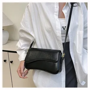 Retro minimalist black crossbody bag detail, stylish PU leather shoulder bag close-up.