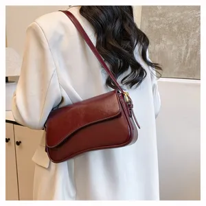 Detailed view of a vintage solid color wine red shoulder bag showcasing premium leather texture.