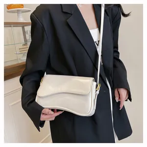Stylish white curved shoulder bag for women, elegant glossy crossbody PU leather handbag.