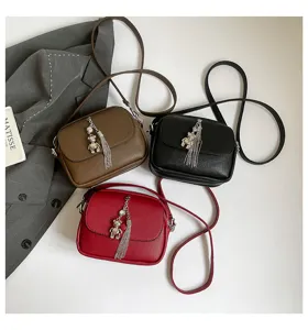 Chic women PU leather tassel small round crossbody shoulder bag with metal bear charm.