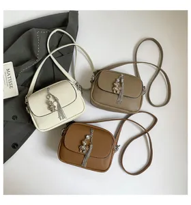 Women's PU leather crossbody bag with cute bear tassel pendant, casual shoulder handbag.
