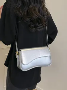 Stylish silver shoulder bag for women, trendy curved design, premium crossbody bag for daily wear.