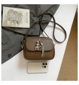 Women vintage brown leather crossbody bag with metal bear pendant and chic tassel charm
