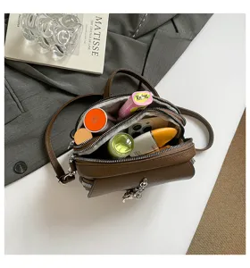 Retro brown leather crossbody bag with multi compartments and chic tassel design for women.