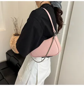 Detailed view of a stylish pink woven texture shoulder bag with metal chain for daily fashion.