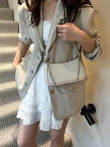 Chic women's woven shoulder bag with chain strap, stylish daily crossbody hobo handbag.