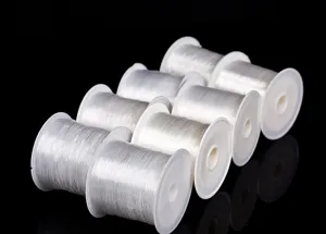 Detail view of clear nylon beading thread spools for DIY crafts and jewelry making.