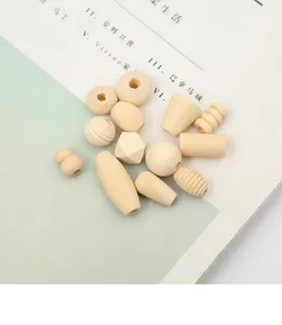 Detail shot of assorted raw wood beads for DIY crafts, various shapes including round and faceted.