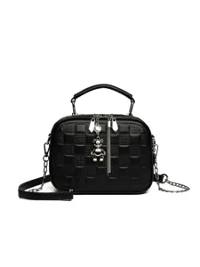 Main image of a stylish black checkered soft leather crossbody handbag with a cute silver bear pendant.