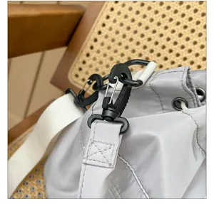 Detailed shot of casual nylon tote bag strap hook, durable hardware and stylish shoulder design.