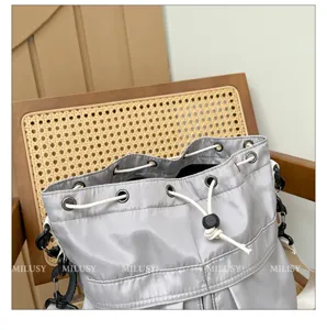 Grey nylon bucket bag with drawstring closure, casual style shoulder bag for daily use.