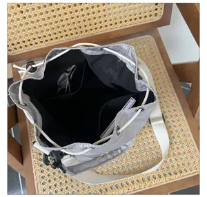 Detailed view of grey drawstring canvas tote bag interior with practical multi pockets inside.