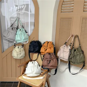 Casual nylon bucket bag with large capacity, trendy solid color shoulder handbag for women.
