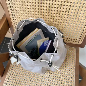 Casual gray nylon drawstring bucket bag, large capacity shoulder tote on rattan chair main