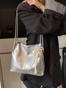 Silver metallic shoulder bag for women, trendy commuter tote with chic lace pearl pendant.