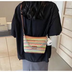 Stylish rainbow woven bucket bag with chain strap, casual straw crossbody bag for summer.