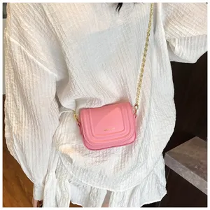 Trendy pink women's cross-body bag with gold chain, chic small square bag for daily wear.