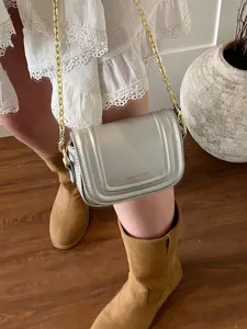 Trendy silver crossbody bag for women, stylish small square purse with metallic chain.