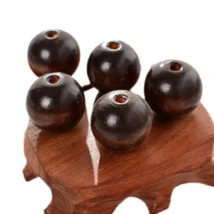 Perles rondes en bois marron foncé pour la fabrication de bijoux et loisirs créatifs.