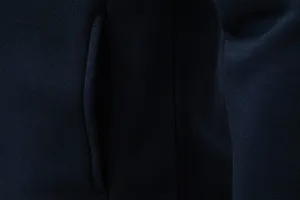 Men's casual hoodie jacket pocket detail, premium navy blue fabric texture close up view.