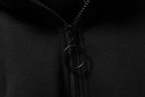 Detailed close-up view of black metal zipper and round ring pull on casual hoodie jacket.