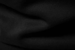 Premium black fabric detail of men's casual hoodie, showing soft texture and fine weave.