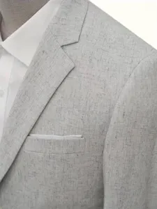 Close-up fabric detail of men's casual grey textured blazer jacket showcasing fine weave.