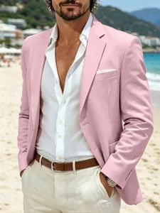 Men's stylish casual pink blazer detail view, slim fit suit jacket on beach background.