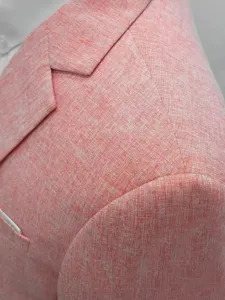 Men's cotton linen suit jacket detail, textured fabric shoulder and lapel close up view