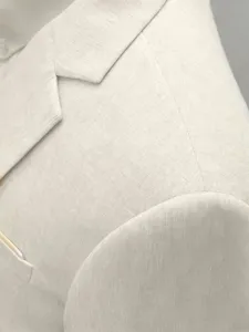 Detail view of a stylish beige cotton linen men's suit jacket, perfect for business casual wear.